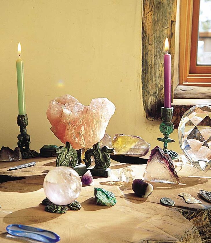 In their bedroom, Tom and Flame display a collection of sacred items, each embodying a reminder of their spiritual path. The home is too small for a designated shrine or meditation room, but placing this altar in the corner of the bedroom creates a spot that reminds the couple of their dedication to spiritual wakefulness first thing in the morning and as they go to sleep at night.